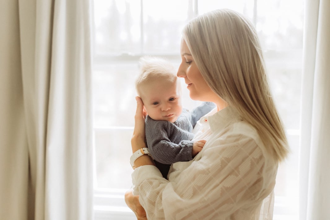 Mother Carrying Baby by the Window